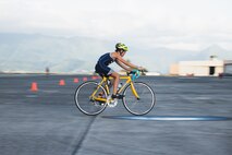 A participant rides in the bicycle portion of the 2023 Marine Corps Base Hawaii Keiki Tradewind Triathlon, Marine Corps Air Station Kaneohe Bay, MCBH, Sept. 23, 2023. The event was organized to promote physical fitness and foster camaraderie among military families. (U.S. Marine Corps photo by Cpl. Brandon Aultman)