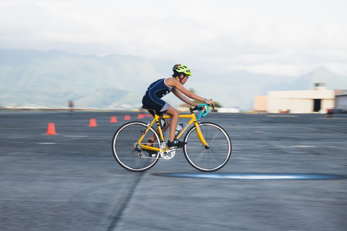 A participant rides in the bicycle portion of the 2023 Marine Corps Base Hawaii Keiki Tradewind Triathlon, Marine Corps Air Station Kaneohe Bay, MCBH, Sept. 23, 2023. The event was organized to promote physical fitness and foster camaraderie among military families. (U.S. Marine Corps photo by Cpl. Brandon Aultman)