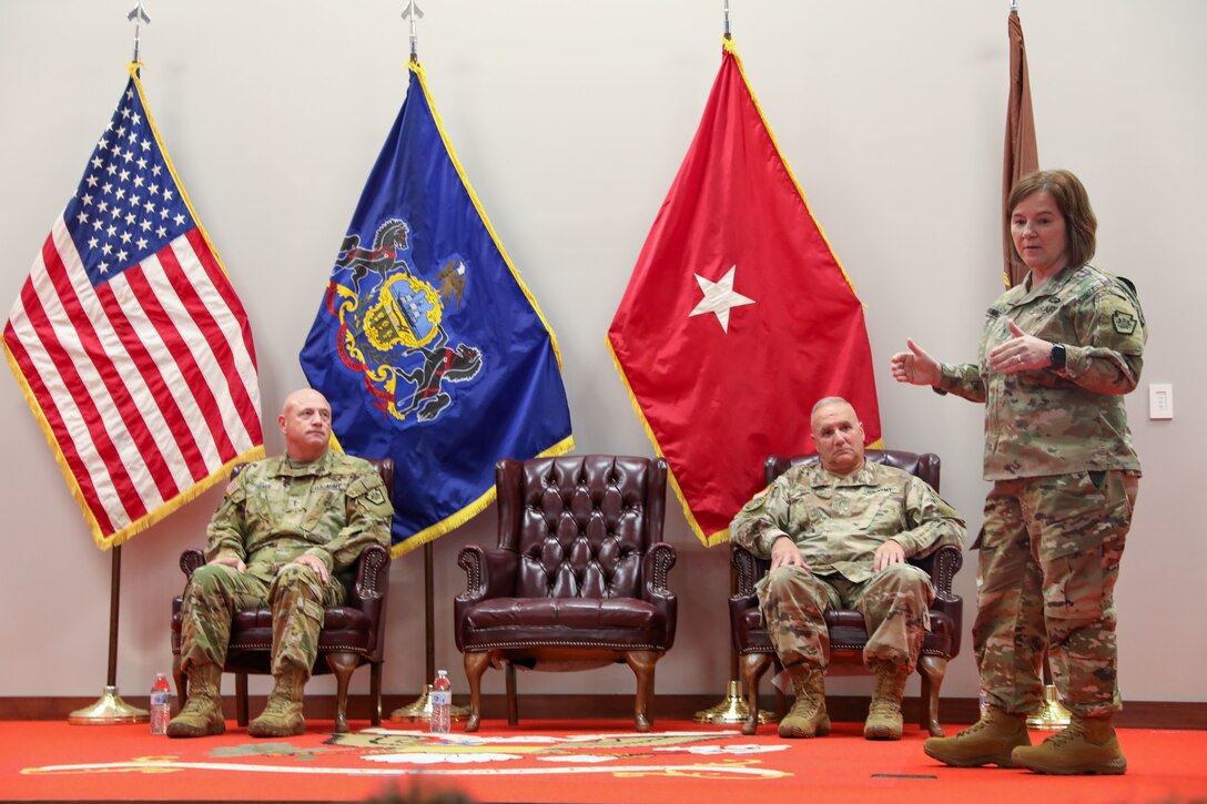 Brig. Gen. Laura McHugh, Pennsylvania National Guard deputy adjutant general-Army, speaks to outgoing Chief Warrant Officer 5 James Fontini, the Pennsylvania Army National Guard’s command chief warrant officer, and Chief Warrant Officer 5 Darren Dreher, incoming CCWO, Oct. 5, 2023, in a change of responsibility ceremony at Fort Indiantown Gap. (U.S. Army National Guard photo by Sgt. 1st Class Zane Craig)