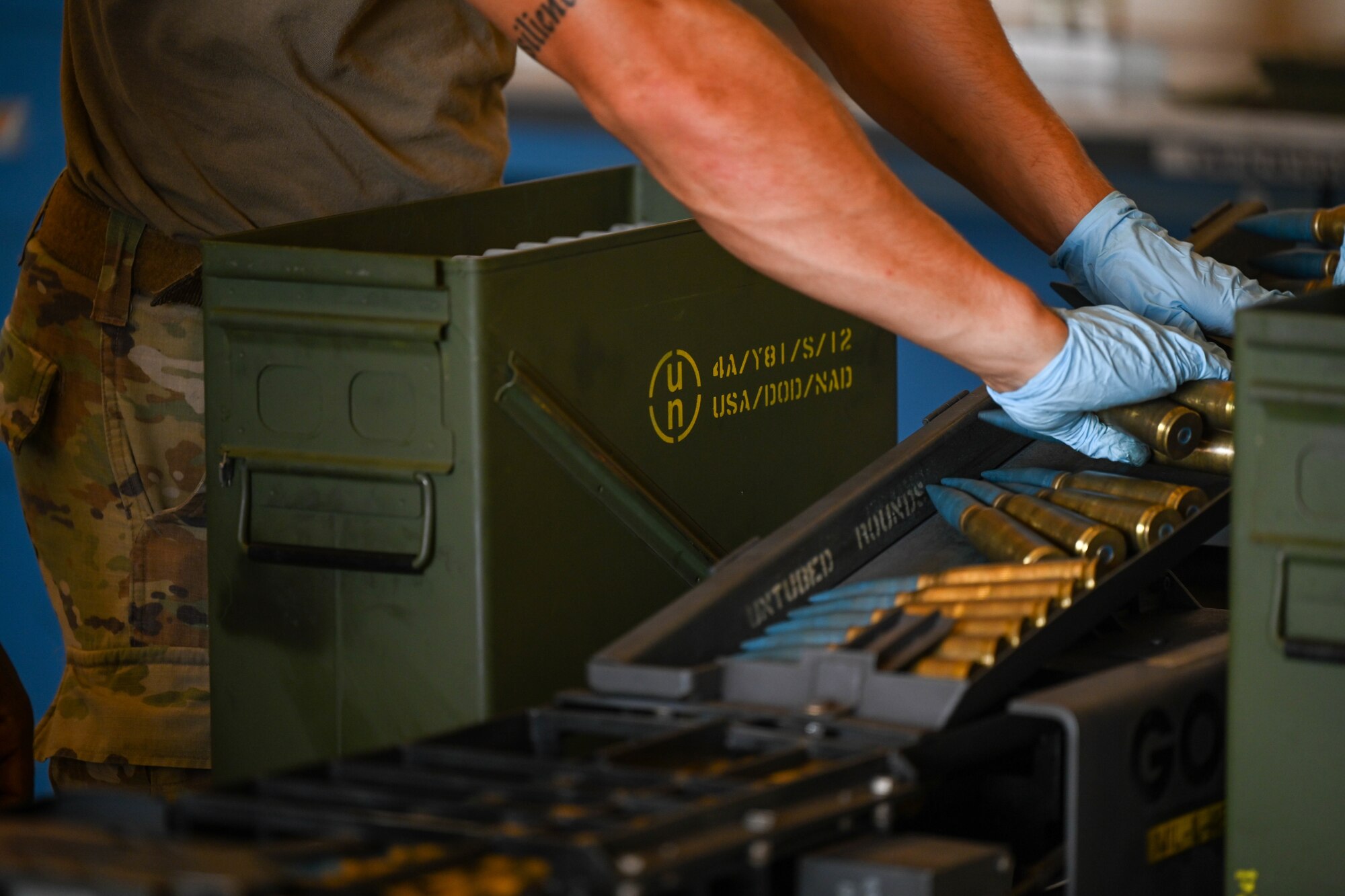 An Airman from the 15th Maintenance Squadron munitions flight, loads 20 mm rounds into a Universal Ammunition Loading System during a training exercise at Joint Base Pearl Harbor-Hickam, Hawaii, Aug. 2, 2023. The UALS is used to arm an F-22 Raptor assigned to the 19th Fighter Squadron. (U.S. Air Force photo by Senior Airman Makensie Cooper)