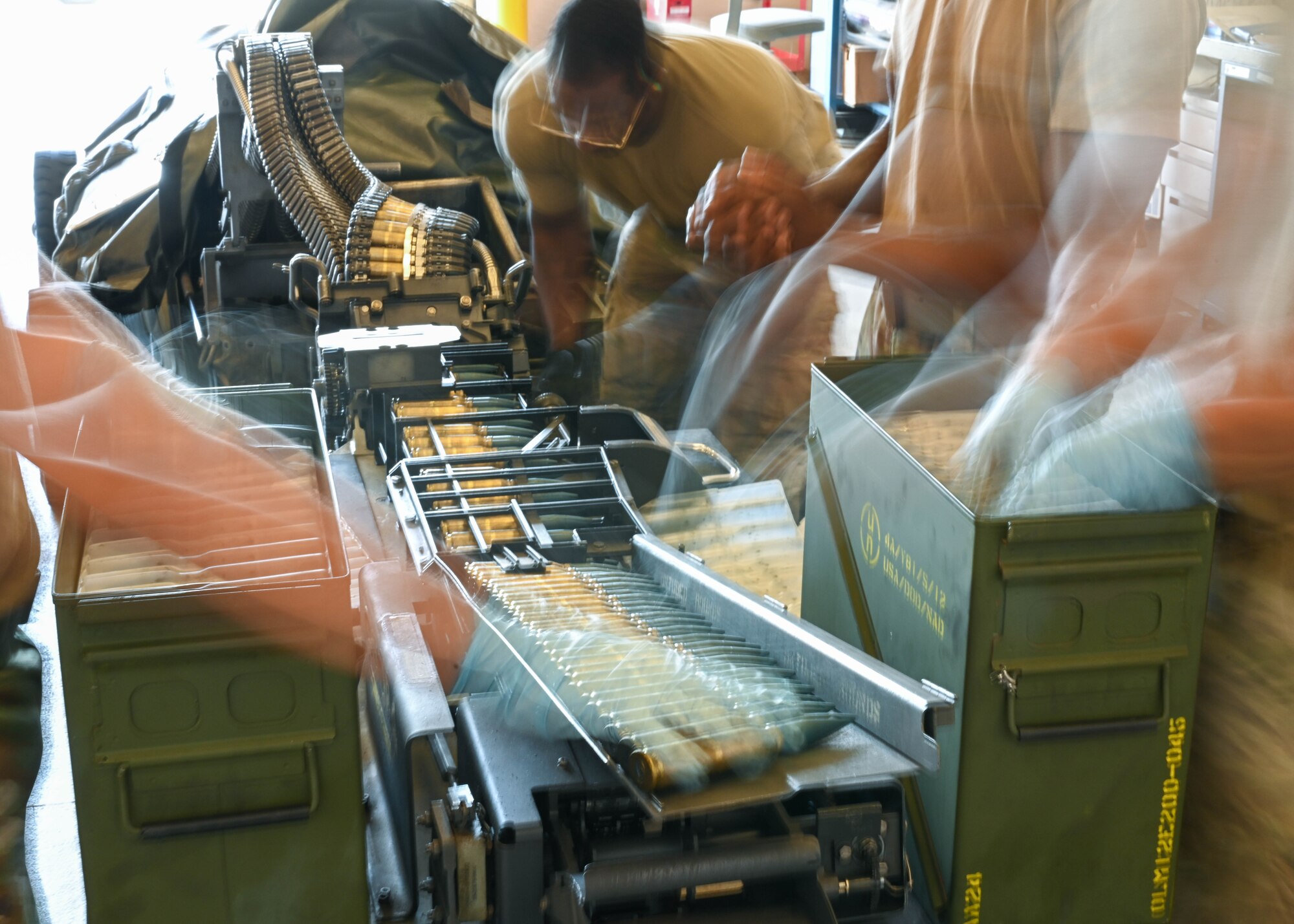 Airmen from the 15th and 154th Maintenance Squadron munitions flights load 20 mm rounds into a Universal Ammunition Loading System at Joint Base Pearl Harbor-Hickam, Hawaii, Aug. 2, 2023. The UALS is used to arm an F-22 Raptor assigned to the 19th Fighter Squadron. (U.S. Air Force photo by Senior Airman Zoie Cox)