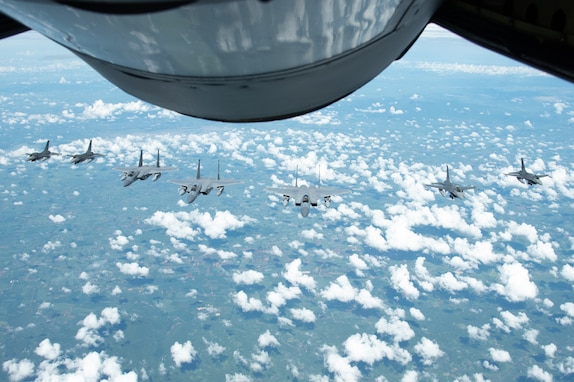 F-15 Eagles from the 142nd Wing, Portland, Oregon and F-16 Vipers  from the Royal Thai Air Force fly in formation over Korat Air Base Royal Kingdom of Thailand during Enduring Partners 2023, Sept. 20, 2023. The two-week engagement served as an opportunity to gain valuable training through combined dissimilar air combat training, air-to-air refueling and ground-controlled interception for the Washington and Oregon Air National Guard and the Royal Thai Air Force. Within two weeks, all participants improved combat readiness and combined and joint interoperability, while enhancing strong defense relations and the State Partnership Program between the two countries.(U.S. Air National Guard photo by Senior Airman Yuki Klein)