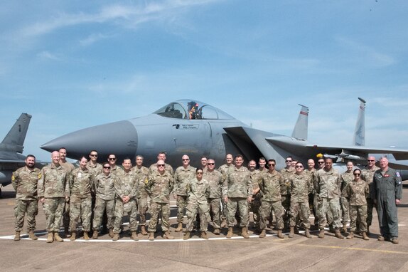 Members from the 142nd Wing, Portland, Oregon stand in front of a U.S. Air Force F-15 Eagle with Lt. Gen. Michael Loh, Director Air National Guard, on Korat Air Base Royal Kingdom of Thailand for Enduring Partners 2023, Sept. 21, 2023. The two week engagement strengthened the relationship between the United States and Thailand, while gaining valuable mission readiness training.  (U.S. Air National Guard photo by Senior Airman Yuki Klein)