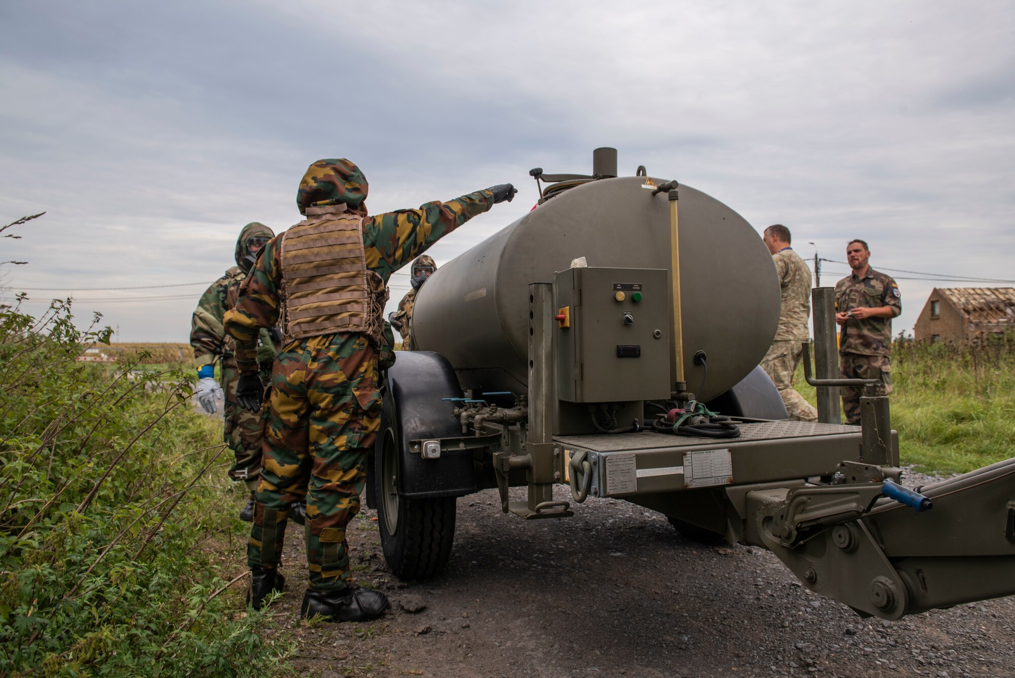 A man points at a tank