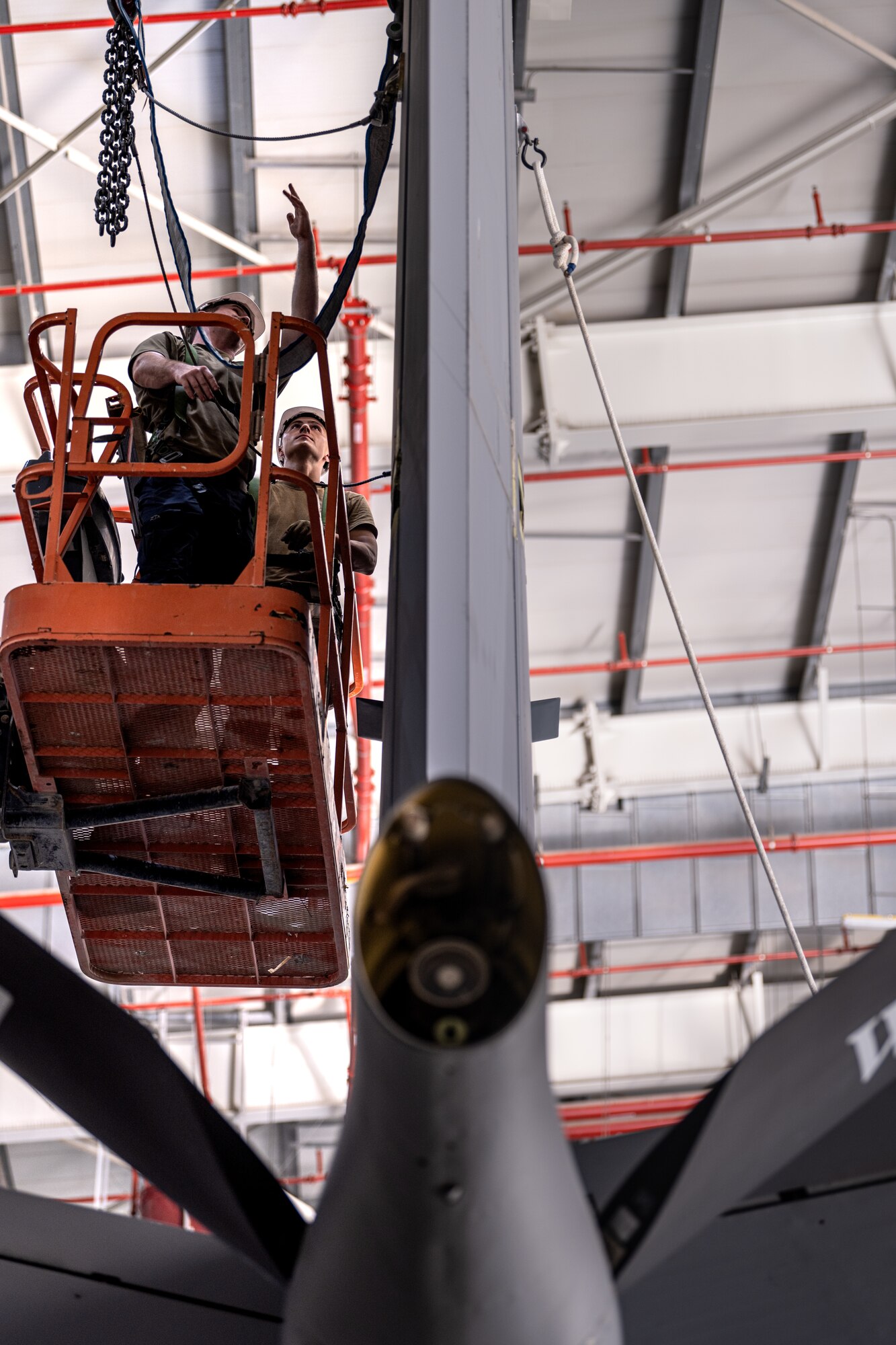 Airmen removing an aircraft tail fin