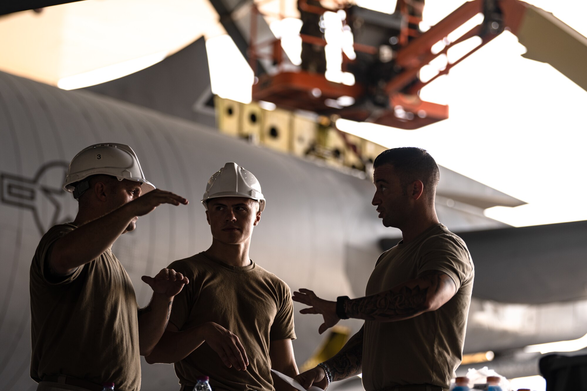 Airmen conversing next to an aircraft
