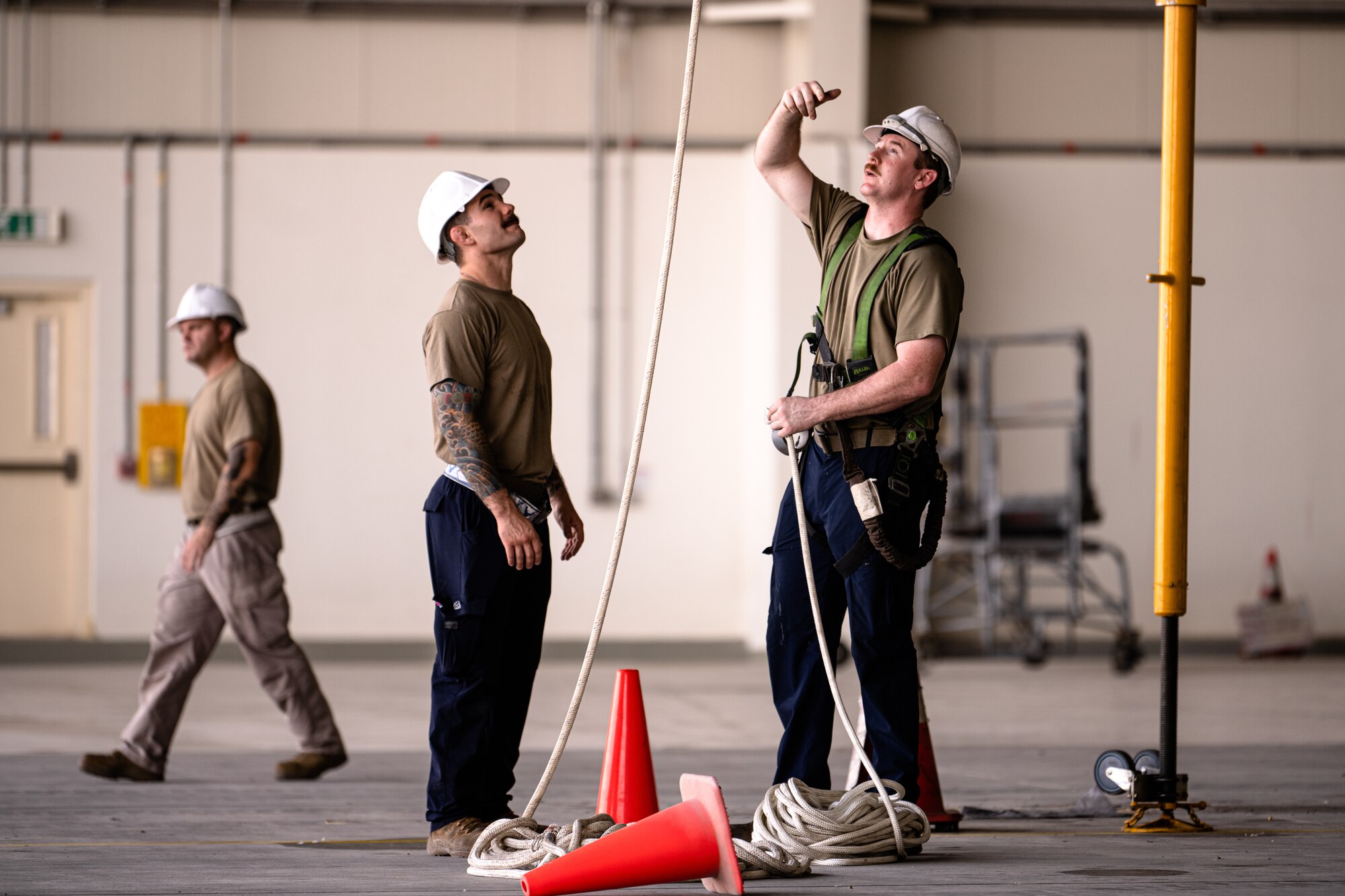 Airmen discussing a process next to an aircraft