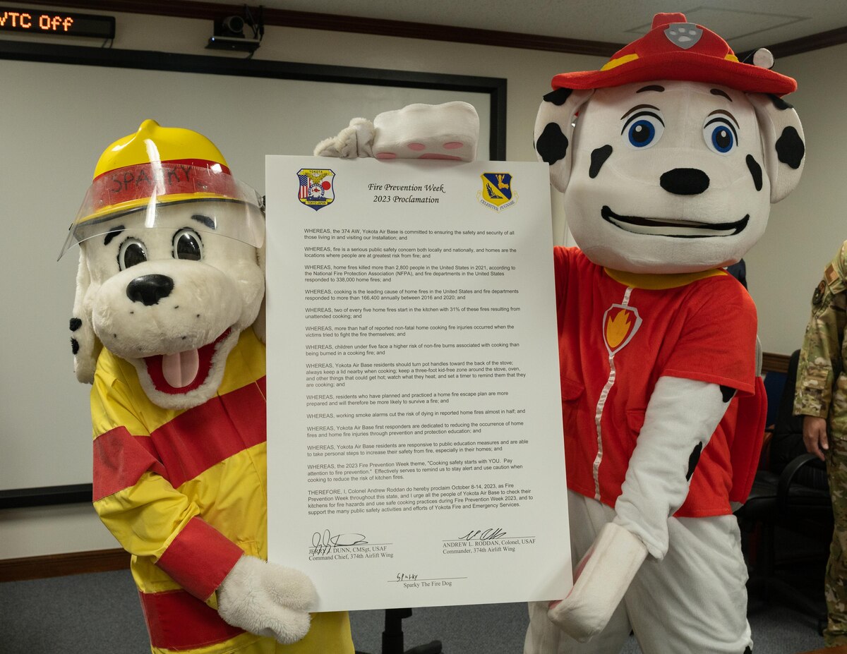 First responder mascots hold the Fire Prevention Week proclamation.