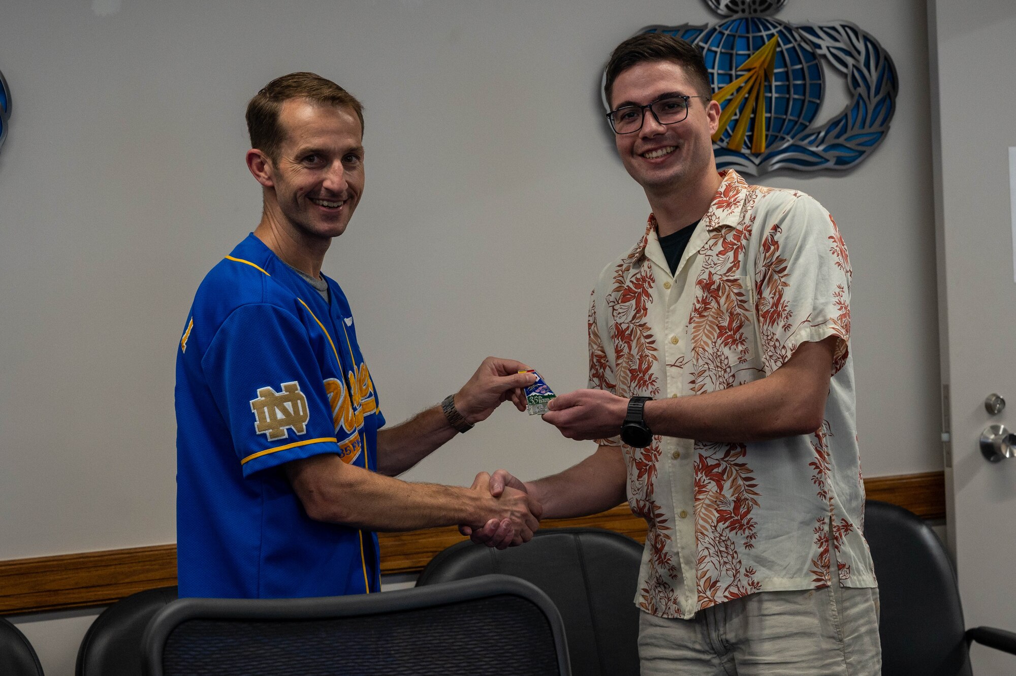 Two individuals pose for a group photo.