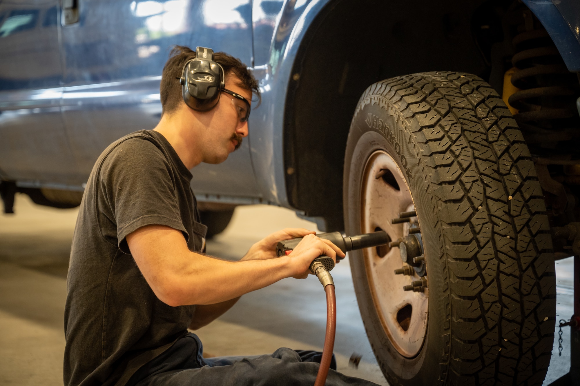 U.S. Air Force Senior Airman Daniel Covell, 51st Logistics Readiness Squadron vehicle management mechanic technician, removes bolts from an axel during a tire change at Osan Air Base, Republic of Korea, Sept. 8, 2023. Routine maintenance on fleet vehicles ensures real-world mission readiness, improving reliability and performance of over 129 types of vehicles which provide a wide variety of services to include flightline support. The vehicles go through the validation process to ensure their utilization meets unit requirements and U.S. Air Force standards. (U.S. Air Force photo by Staff Sgt. Kelsea Caballero)