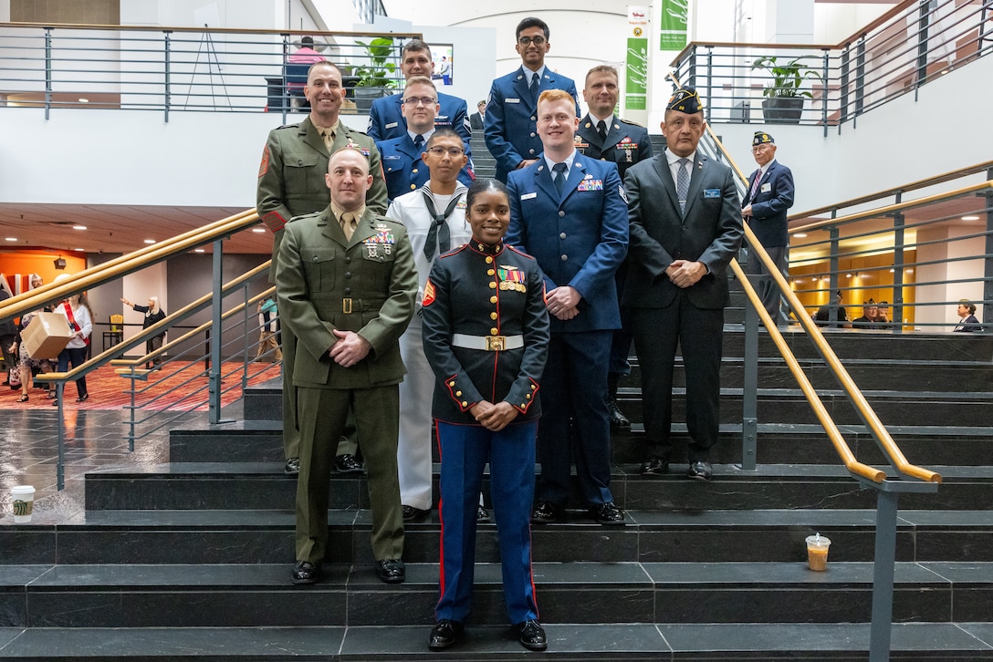 U.S. Marine Corps Sgt. Nhatalyne Bordes, first row, a legal chief, office of the Staff Judge Advocate, with Headquarters and Headquarters Squadron, Marine Corps Air Station New River poses for a group photo during the 104th American Legion National Convention in Charlotte, North Carolina, Aug. 29, 2023. Bordes received the 2023 American Legion Spirit Service Award for the U.S. Marine Corps. (U.S. Marine Corps photo by Cpl. Jennifer E. Douds)