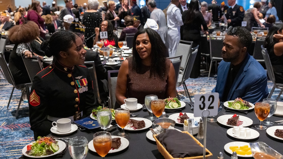 U.S. Marine Corps Sgt. Nhatalyne Bordes, left, a legal chief, office of the Staff Judge Advocate, with Headquarters and Headquarters Squadron, Marine Corps Air Station New River sits with her parents during the 104th American Legion National Convention in Charlotte, North Carolina, Aug. 29, 2023. Bordes received the 2023 American Legion Spirit Service Award for the U.S. Marine Corps. (U.S. Marine Corps photo by Cpl. Jennifer E. Douds)