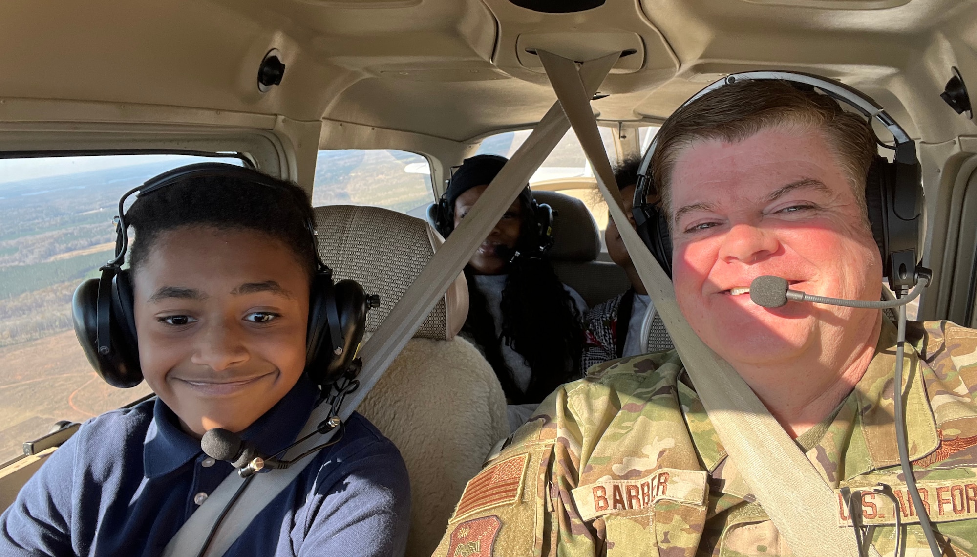 Lt. Col. Shawn Barber pilots junior ROTC students during an orientation flight. (Courtesy photo)