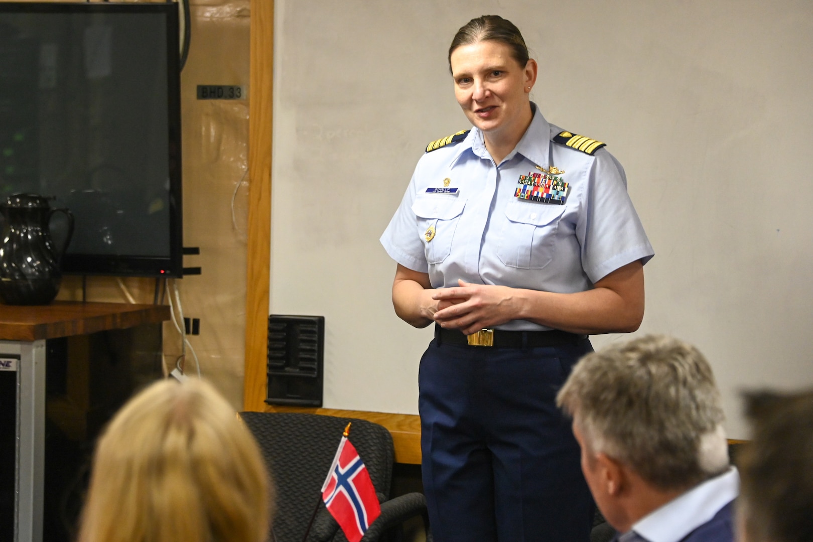 U.S. Coast Guard Capt. Michele Schallip, commanding officer of the U.S. Coast Guard Cutter Healy (WAGB 20) welcomes guests aboard the Healy for a scientific roundtable, in Tromsø, Norway, Oct. 3, 2023. The Healy conducted joint operations with the Norwegian Coast Guard Vessel Svalbard, hosted a U.S. Coast Guard Research and Development Center (RDC) “science roundtable,” and welcomed aboard guests from a variety of institutions with interest in the Arctic and Healy’s science mission. (U.S. Coast Guard photo by Senior Chief Petty Officer Charly Tautfest)