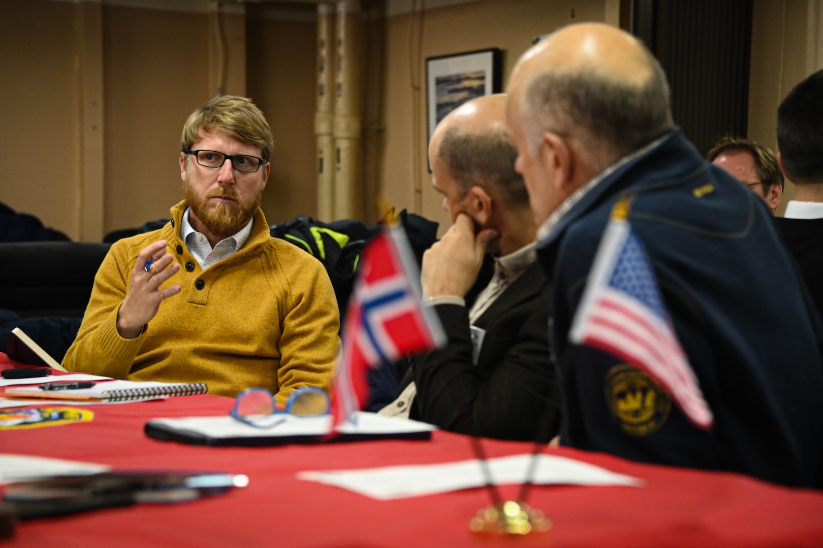 Adam VanDervort, American Presence. Post Officer, Michael Mayer, Norwegian Defence Research Establishment, and Harold Steen, Research Director for Norwegian Polar Institute, attend a science roundtable aboard the U.S. Coast Guard Cutter Healy (WAGB 20), while moored in Tromsø, Norway, Oct. 3, 2023. The science roundtable brought together researchers and operators from the U.S., Norway, and Canada to discuss best practices in search and rescue, environmental protection, and vessel safety and navigation in the Arctic. (U.S. Coast Guard photo by Senior Chief Charly Tautfest)