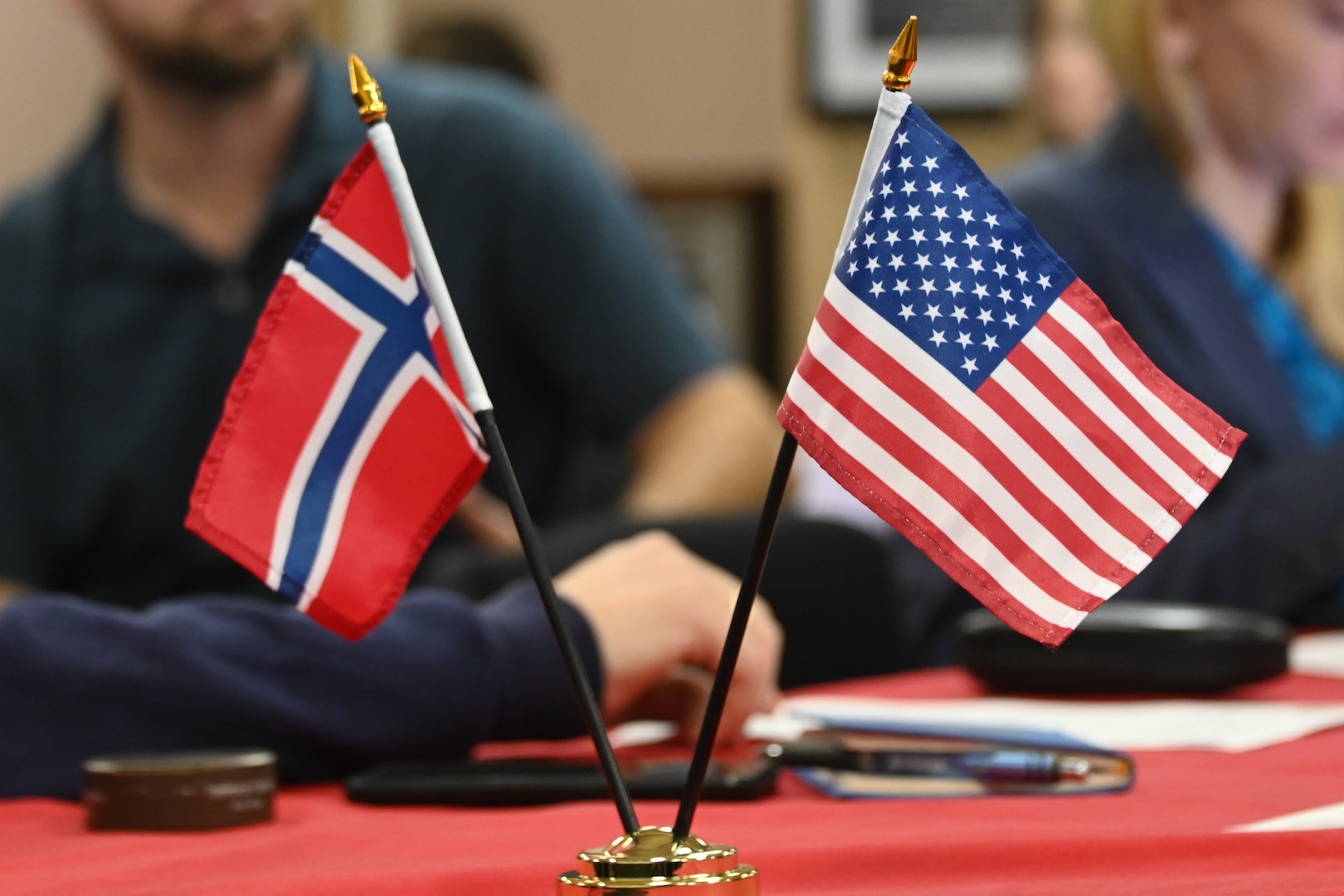 The Norwegian and U.S. flags are displayed during a science roundtable aboard the U.S. Coast Guard Cutter Healy (WAGB 20), while moored in Tromsø, Norway, Oct. 3, 2023. The science roundtable brought together researchers and operators from the U.S., Norway, and Canada to discuss best practices in search and rescue, environmental protection, and vessel safety and navigation in the Arctic. (U.S. Coast Guard photo by Senior Chief Charly Tautfest)