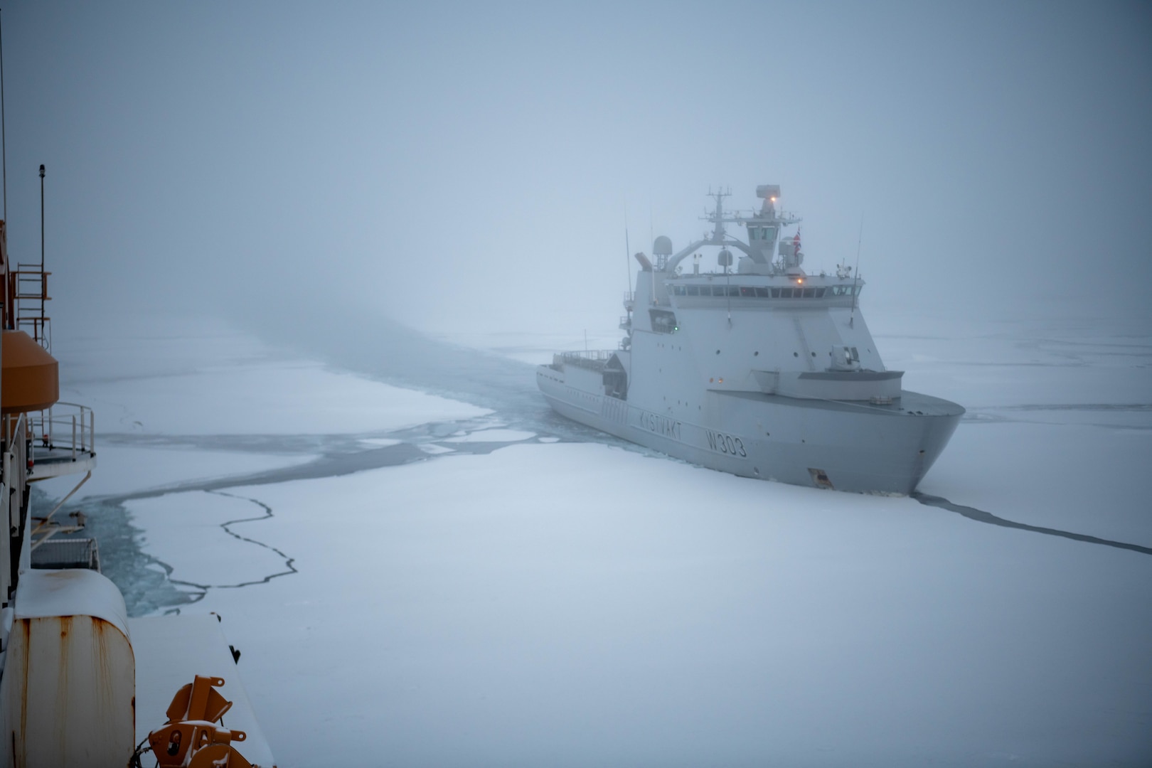U.S. Coast Guard Cutter Healy (WAGB 20) and Norwegian Coast Guard Vessel Svalbard steam in formation through ice on Sep. 27, 2023, in the Barents Sea while en route to conduct joint exercises in northern Norway. The Healy is deployed to the arctic to develop interoperability with allies and to support responsibilities and shared interests throughout the Arctic region. (U.S. Department of Defense photo by Sgt. Carter Acton)
