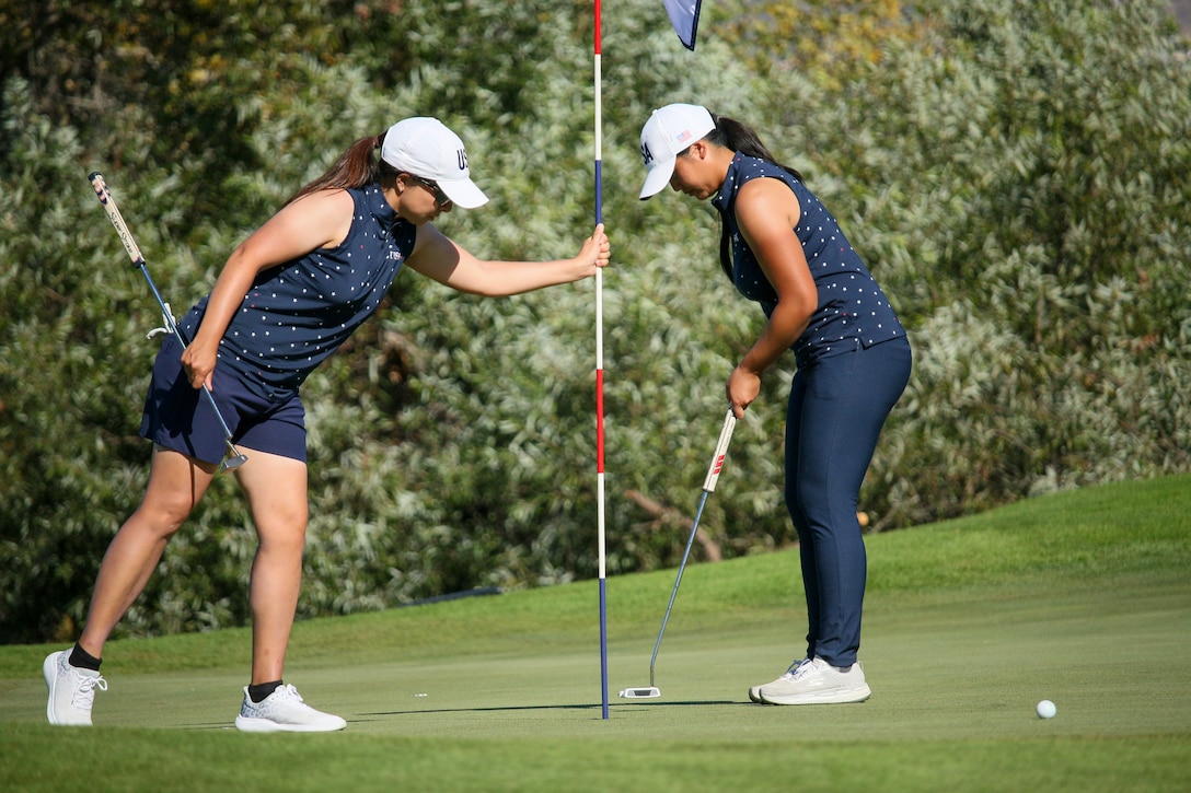 USA's Army Capt. Melanie De Leon of Fort Cavazos, Texas and Air Force 1st Lt. Kimberly Liu of Minot AFB, N.D. finish up the 18th hole during the 14th Edition of the Conseil International du Sport Militaire (CISM) World Military Golf Championship held at the Admiral Baker Golf Course in San Diego, Calif., hosted by Naval Base San Diego, Calif.  Nations from Bahrain, Canada, Denmark, Dominican Republic, Estonia, France, Germany, Ireland, Italy, Kazakhstan, Kenya, Latvia, Netherlands, Sri Lanka, Tanzania, Zimbabwe, and host USA compete for gold. Department of Defense Photo by Mr. Steven Dinote - Released.