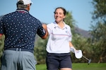 France's Pauline Stein receives a congratulatory fist bump from USA Coach Gerald Dremel after taking the top spot of the leaderboard after round three of the 14th Edition of the Conseil International du Sport Militaire (CISM) World Military Golf Championship held at the Admiral Baker Golf Course in San Diego, Calif., hosted by Naval Base San Diego, Calif.  Nations from Bahrain, Canada, Denmark, Dominican Republic, Estonia, France, Germany, Ireland, Italy, Kazakhstan, Kenya, Latvia, Netherlands, Sri Lanka, Tanzania, Zimbabwe, and host USA compete for gold. Department of Defense Photo by Mr. Steven Dinote - Released.