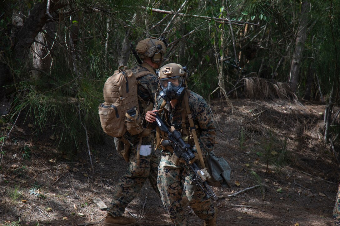 U.S. Marine Corps Lance Cpl. Patrick Romero, a student in the Advanced Infantry Marine Course with Advanced Infantry Training Battalion, School of Infantry-West, Hawaii Detachment, rushes to post security during a simulated chemical attack, Kahuku Training Area, June 27, 2023. AIMC is advanced infantry training designed to enhance and test Marines’ skills with a focus on reinforcing proper patrols and operational procedures. (U.S. Marine Corps photo by Lance Cpl. Terry Stennett III)