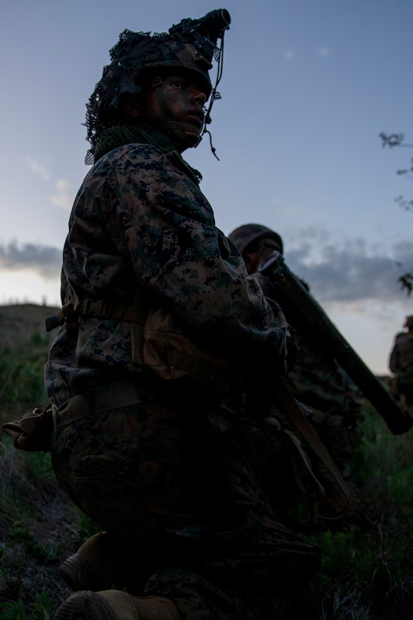 A U.S. Marine with Alpha Company, Infantry Training Battalion, School of Infantry - West, kneels during a night patrol as part of the tenth week of the Infantry Marine Course on Marine Corps Base Camp Pendleton, California, April 1, 2021. IMC is a 14-week pilot course designed to create better trained and more lethal entry-level infantry Marines prepared for near-peer conflicts. The course uses a redesigned learning model for students intended to develop their capabilities for independent and adaptive thought and action. The program of instruction for IMC has been in development for a year and follows guidance from the 2019 Commandant's Planning Guidance and Force Design 2030. (U.S. Marine Corps photo by Lance Cpl. Kerstin Roberts)