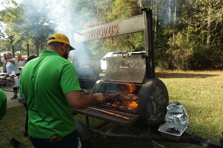 Volunteers prepare burgers and hotdogs for more than 700 people attending “Special Day for Special People” event, on Thursday, October 5, 2023.  Groups of mentally and physically challenged individuals of all ages in the local community were invited to attend as well as several elderly groups.