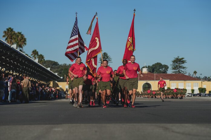 U.S. Marines with Bravo Company, 1st Recruit Training Battalion, Recruit Training Regiment, carry the colors during a motivational run at Marine Corps Recruit Depot San Diego, Oct. 5, 2023. The motivational run is the last physical training event Marines conduct while at MCRD San Diego before they graduate. (U.S. Marine Corps photo by Lance Cpl. Francisco Angel)