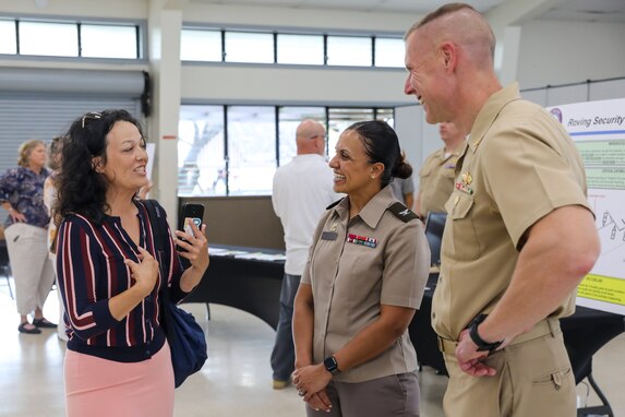 Joint Task Force-Red Hill (JTF-RH) Repairs and Maintenance Director, U.S. Navy Capt. Steve Stasick, and JTF-RH Quality Assurance Director, U.S. Army Col. Letsy Ann Perez-Marsden, speak to a local resident during the defueling open house at Ke’ehi Lagoon Memorial in Honolulu, Hawaii, Oct. 3, 2023.