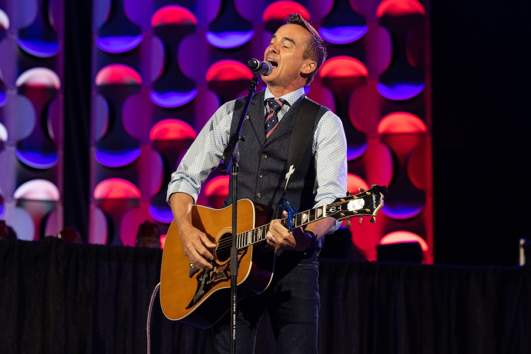 Keni Thomas, a former U.S. Army Ranger, sings a song during the 104th American Legion National Convention in Charlotte, North Carolina, Aug. 29, 2023. During the convention Sgt. Nhatalyne Bordes received the 2023 American Legion Spirit Service Award for the U.S. Marine Corps. (U.S. Marine Corps photo by Cpl. Jennifer E. Douds)