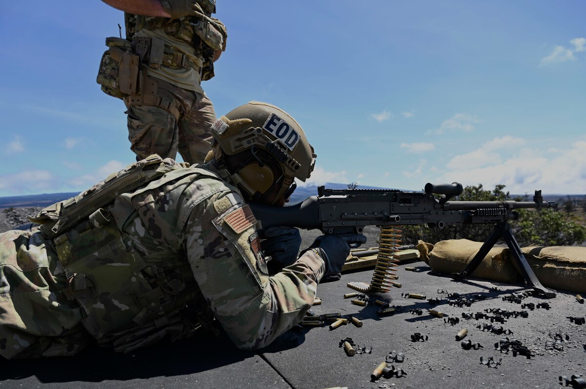 An Airmen fires an M4 carbine rifle at pop-up targets.