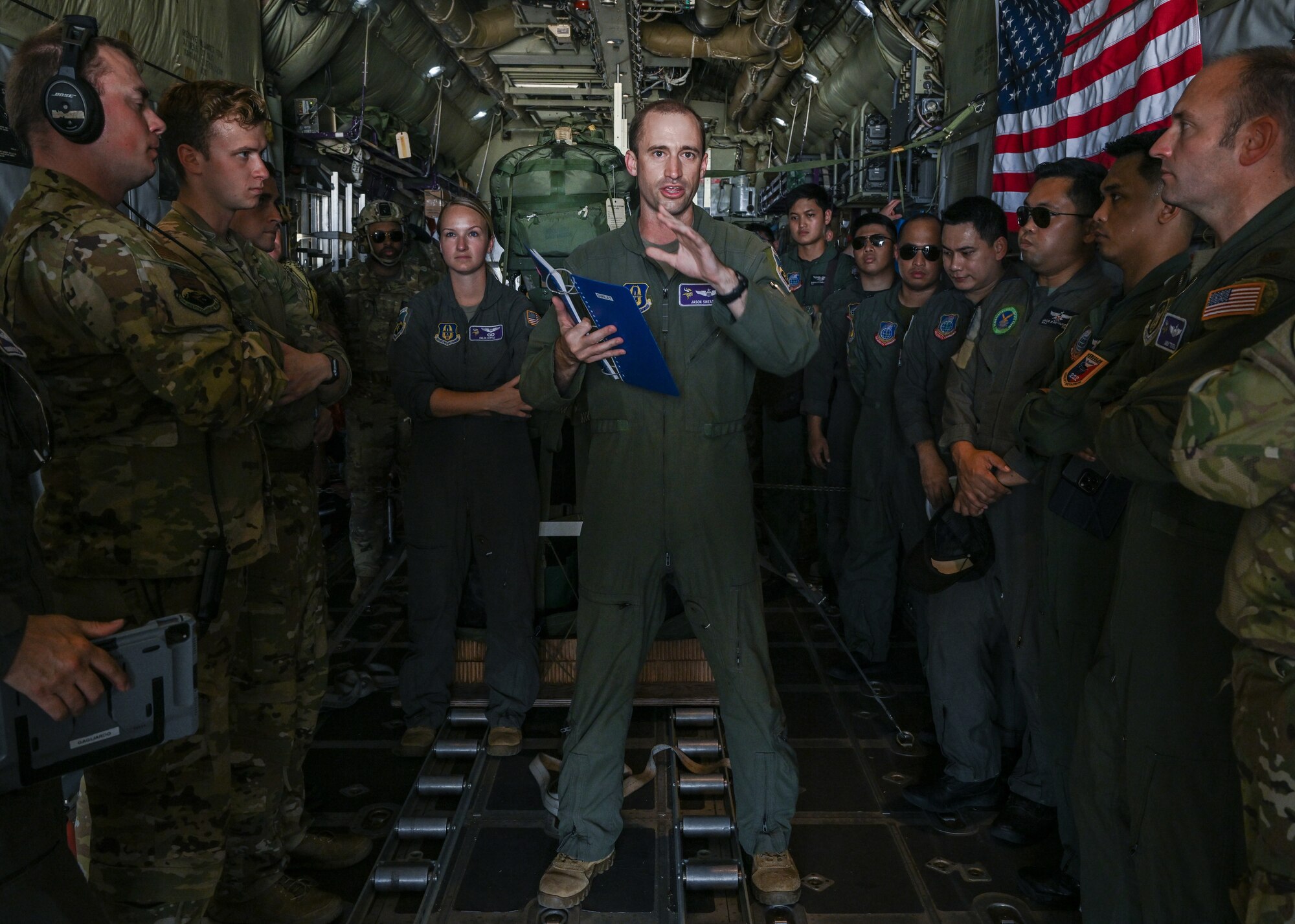 Air Force Reserve pilot briefs others in back of aircraft prior to take-off.