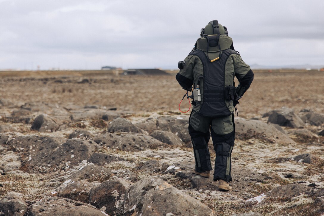 U.S. Marine Corps Staff Sgt. Mark Frick, a native of Baltimore, Maryland and explosive ordnance disposal team leader with the 26th Marine Expeditionary Unit (Special Operations Capable) (26MEU(SOC)), approaches a simulated improvised explosive device during Exercise Northern Challenge 2023, Keflavik Airport, Iceland, Sept. 22, 2023. Northern Challenge 23 is an Icelandic Coast Guard-led bomb disposal exercise, hosted to train teams from over a dozen nations with response to incidents involving simulated improvised and military explosive devices. The San Antonio-class amphibious transport dock ship USS Mesa Verde (LPD 19), assigned to the Bataan Amphibious Ready Group and embarked 26MEU(SOC), under the command and control of Task Force 61/2, is on a scheduled deployment in the U.S. Naval Forces Europe area of operations, employed by U.S. Sixth Fleet to defend U.S., Allied, and partner interests. (U.S. Marine Corps photo by Cpl. Kyle Jia)