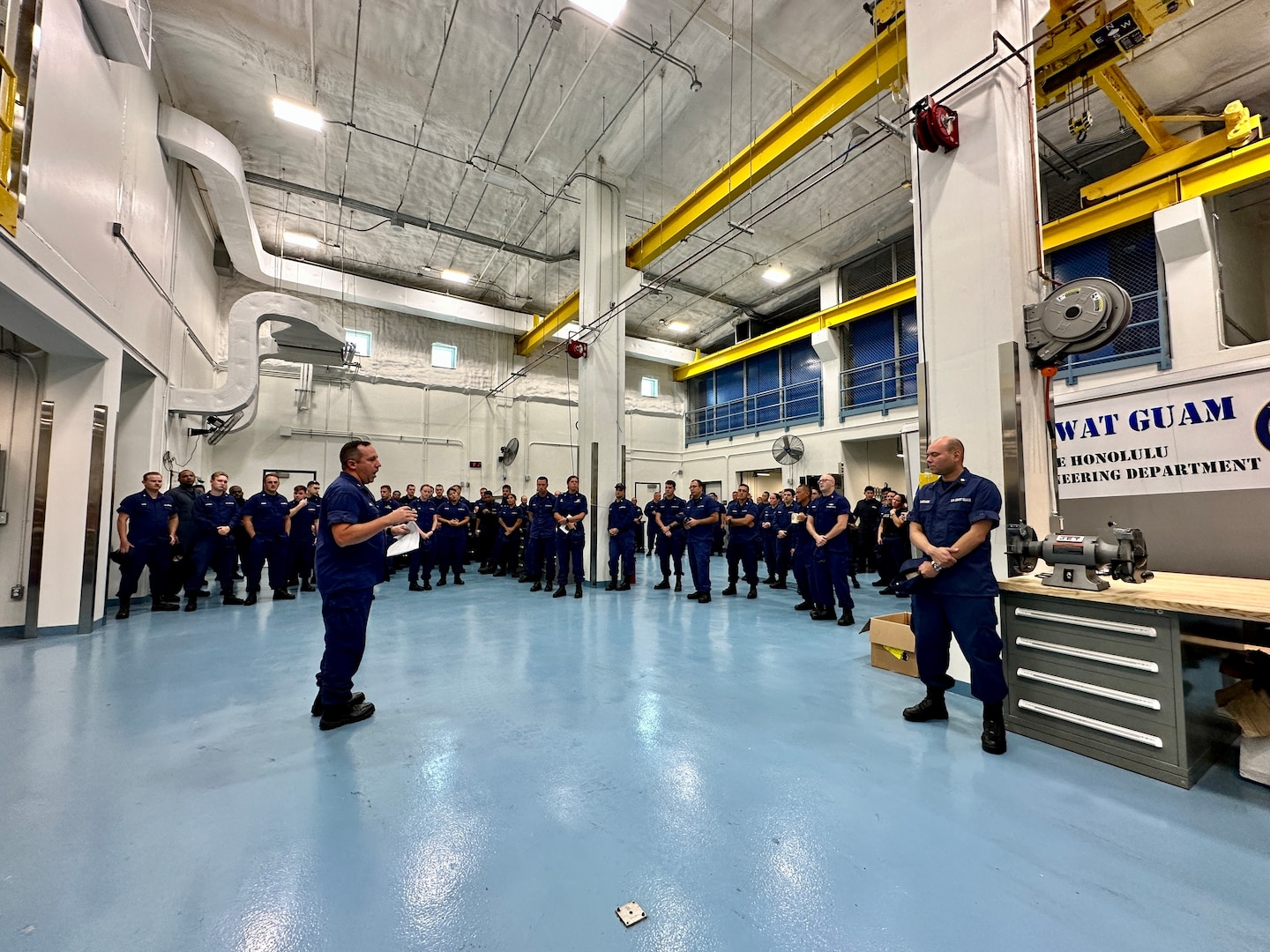 Cmdr. Jason Mitchell, logistics department head of U.S. Coast Guard Forces/Micronesia Sector Guam, discusses storm preparation with the assembled crews from FM/SG, Base Guam, MAT/WAT Guam, and DOL-X, ESD Guam and USCGC Hickory (WLB 212) at the unit in Guam ahead of Tropical Storm Bolaven on Oct. 9, 2023. Tropical Storm Bolaven strengthened after passing through the Federated States of Micronesia and is forecast to intensify through Tuesday afternoon, possibly becoming a typhoon. (U.S. Coast Guard photo by Chief Warrant Officer Sara Muir)