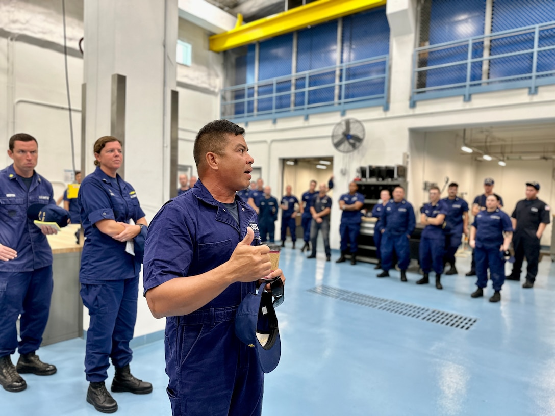 Chief Warrant Officer Manny Pangelinan, engineering officer for U.S. Coast Guard Forces/Micronesia Sector Guam, lays out tasking for assembled crews from FM/SG, Base Guam, MAT/WAT Guam, and DOL-X, ESD Guam and USCGC Hickory (WLB 212) to harden the unit ahead of Tropical Storm Bolaven on Oct. 9, 2023. Tropical Storm Bolaven strengthened after passing through the Federated States of Micronesia and is forecast to intensify through Tuesday afternoon, possibly becoming a typhoon. (U.S. Coast Guard photo by Chief Warrant Officer Sara Muir)