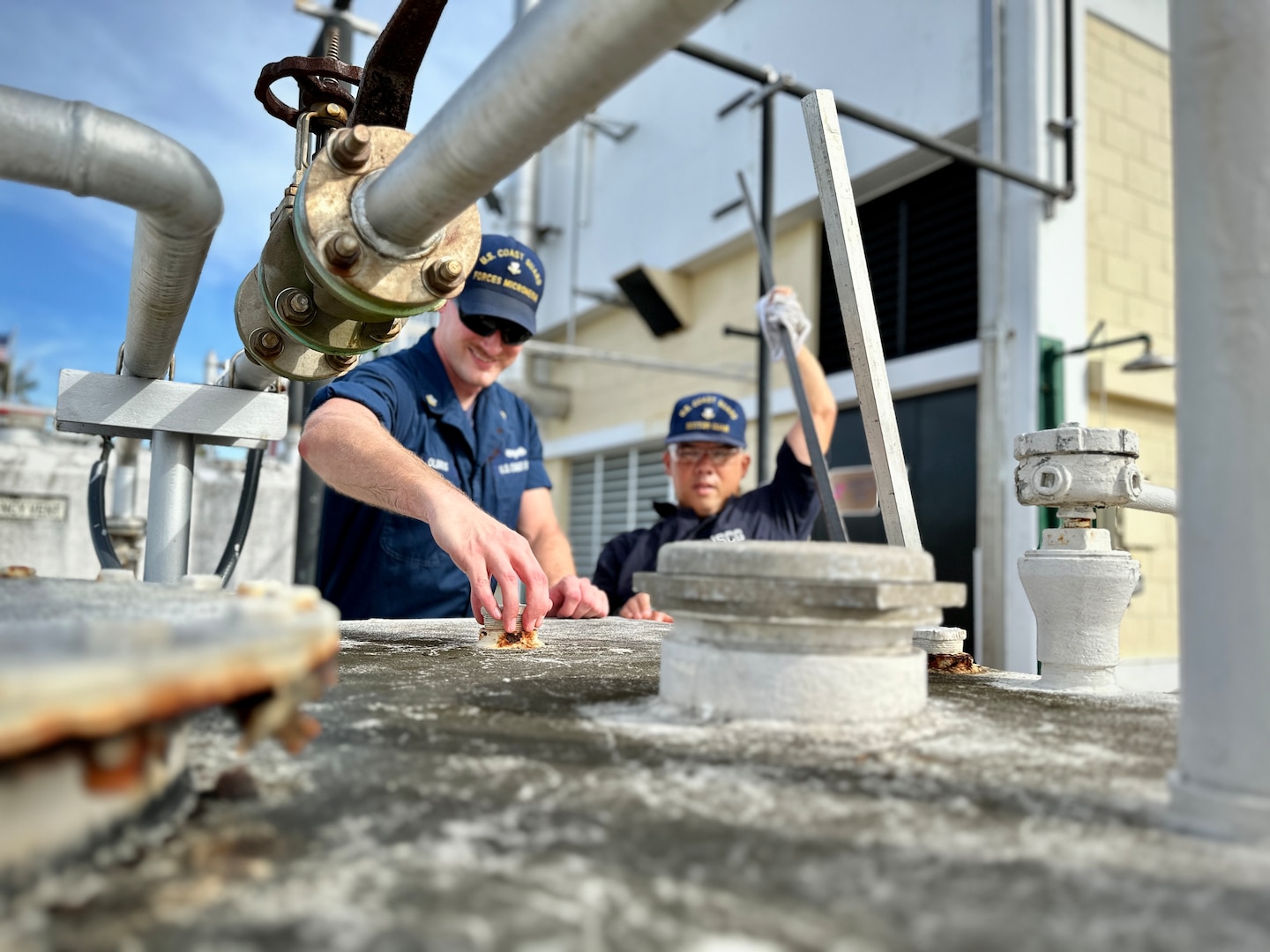 Members of U.S. Coast Guard Forces Micronesia/Sector Guam engineering verify fuel levels on the unit's storage tanks for the emergency generators as crews conduct storm preparations in Guam ahead of Tropical Storm Bolaven on Oct. 9, 2023. Tropical Storm Bolaven strengthened after passing through the Federated States of Micronesia and is forecast to intensify through Tuesday afternoon, possibly becoming a typhoon. (U.S. Coast Guard photo by Chief Warrant Officer Sara Muir)