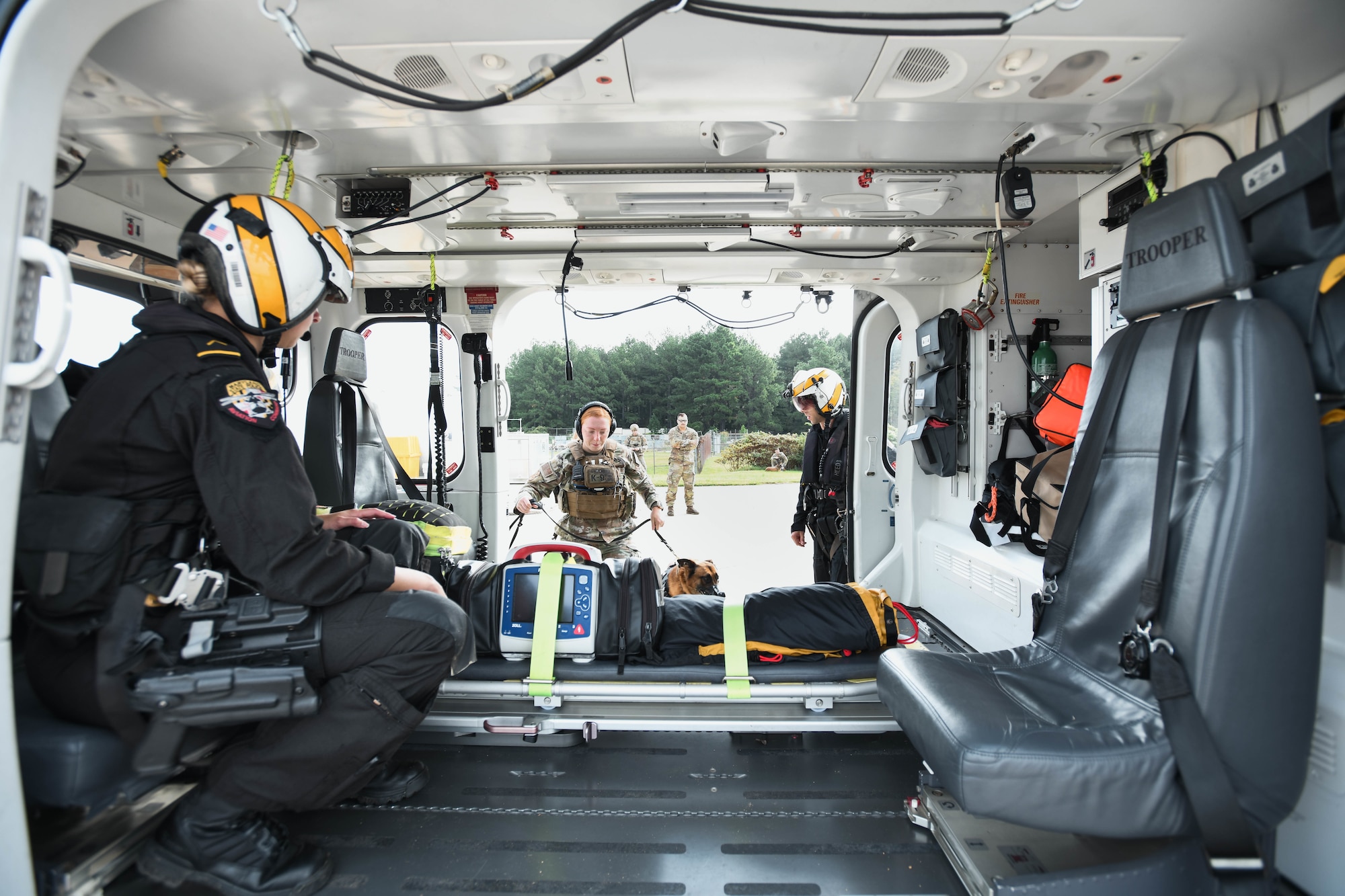 Women get into a helicopter with her dog.