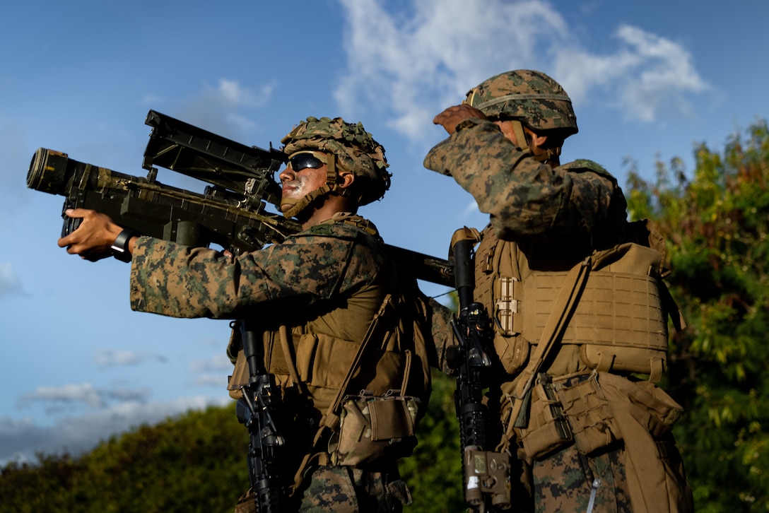 U.S. Marine Corps Lance Cpl. Paul Ruiz, left, and Pfc. Engel Ogandociprian use the FIM-92 Stinger to notionally conduct short range air defense during Force Design Integration Exercise at Pacific Missile Range Facility, Barking Sands, Hawaii, Sept. 26, 2023. Force Design Integration Exercise demonstrates the current capabilities of 3d Marine Littoral Regiment as an effective part of the Stand-in Force integrated with our Pacific Marines and Joint counterparts. Through the demonstration of Force Design 2030-enabled capabilities, 3d MLR showcases the implementation of technology, doctrine, and policy initiatives to allow the SiF to sense and make sense of potential adversaries, seize and hold key maritime terrain, and conduct reconnaissance and counter-reconnaissance. Ruiz and Oandociprian are both low-altitude air defense gunners with 3d Littoral Anti-Air Battalion, 3d MLR, 3d Marine Division. Ruiz is a native of La Mirada, Calif. Ogandociprian is a native of New York City, NY. (U.S. Marine Corps photo by Lance Cpl. Malia Sparks)