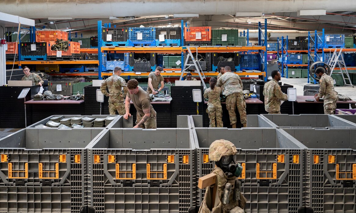 A photo of several Airmen checking in customers’ items.