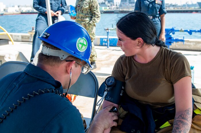 Hospital Corpsman 2nd Class Aidan Rispens, left, and Damage Controlman 3rd Class Faren Brown Glenn, both assigned to amphibious assault ship USS Essex (LHD 2), conduct pier training during a damage control assessment aboard Essex in San Diego, Sept. 28, 2023. Essex is homeported in San Diego, conducting a maintenance period to upgrade and refurbish many key systems aboard. (U.S. Navy photo by Mass Communication Specialist 2nd Class Donita Burks)