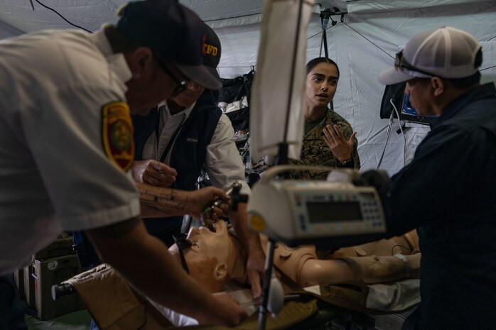 U.S. Navy Corpsman Nadia Fakhari, a native of Orange County, California, with 1st Medical Battalion, explains the capabilities of the Forward Resuscitative Surgical System to San Francisco paramedics and visitors at the Humanitarian Assistance + Village STEM Education Center during San Francisco Fleet Week 2023 at Marina Green, San Francisco, Oct. 8, 2023. San Francisco Fleet Week is an annual public event that honors the contributions of the men and women of the United States Armed Forces while advancing cooperation and knowledge among civilian- and military-based humanitarian assistance personnel. (U.S. Marine Corps Lance Cpl. Hannah Hollerud)