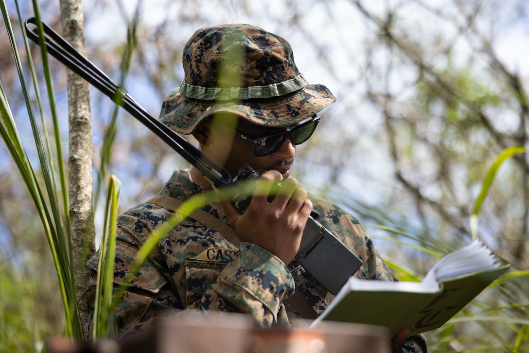 U.S. Marine Corps Cpl. Edwin Castro, a motor transportation operator with 3d Littoral Logistics Battalion, 3d Marine Littoral Regiment, 3d Marine Division, conducts a radio check during a land navigation exercise at Marine Corps Training Area Bellows, Hawaii, July 31, 2023. The purpose of this training was for Marines with 3d LLB to sharpen their land navigation skills in order to enhance their future warfighting capabilities. (U.S. Marine Corps photo by Lance Cpl. Malia Sparks)