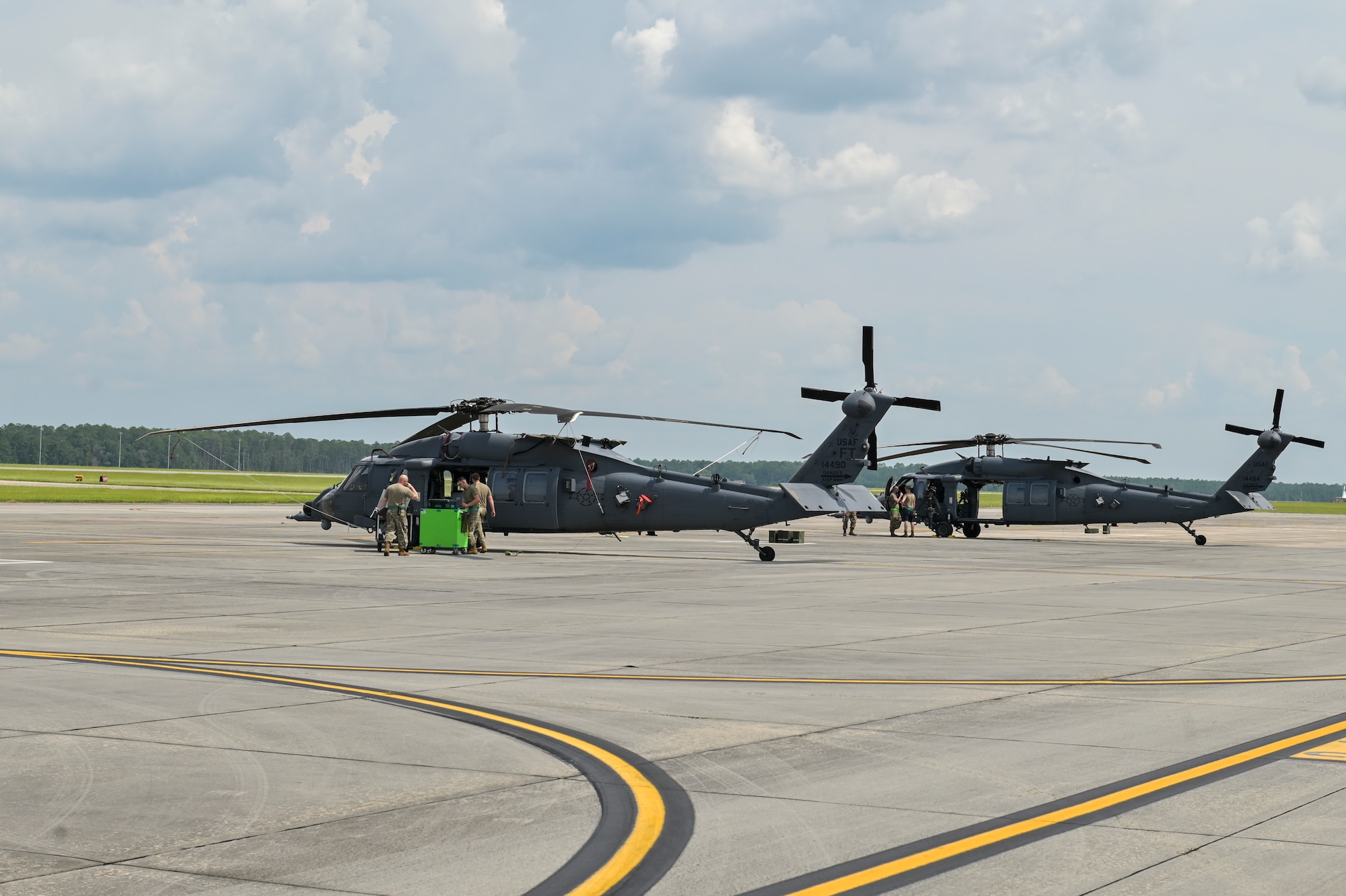 Crews work on two HH-60W Jolly Green II at Moody Air Force Base, Georgia, July 25, 2023. HH-60W “Whiskey” is an upgraded model based on UH-60M “Black Hawk” with double the fuel capacity and improved weapons and sensor capabilities. (U.S. Air Force photo by Airman 1st Class Leonid Soubbotine)