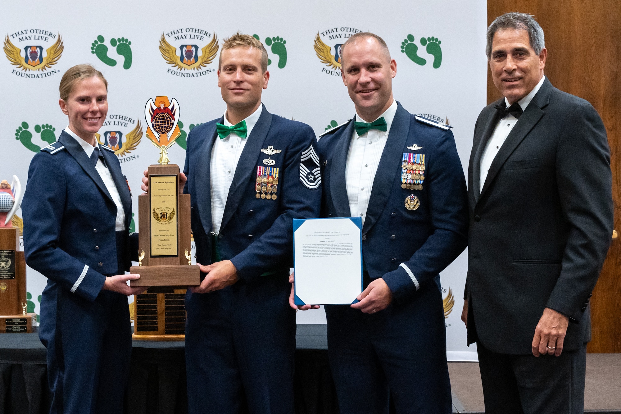 That Others May Live Foundation (TOMLF) Chairman, Todd Bolger, right, poses for a picture alongside the 2023 TOMLF Rescue Squadron of the Year award recipients assigned to the 41st Rescue Squadron, 347th Rescue Group, 23rd Wing from Moody Air Force Base, Georgia, at the 2023 Air Rescue Awards Gala in Las Vegas, Nevada, Sept. 23, 2023. The squadron supported 63 combined joint task force operations in the horn of Africa, airlifting crucial supplies to multiple combat outposts and executing eight casualty evacuation missions saving 22 partner force lives. (U.S. Air Force photo by Airman 1st Class Elizabeth Tan)