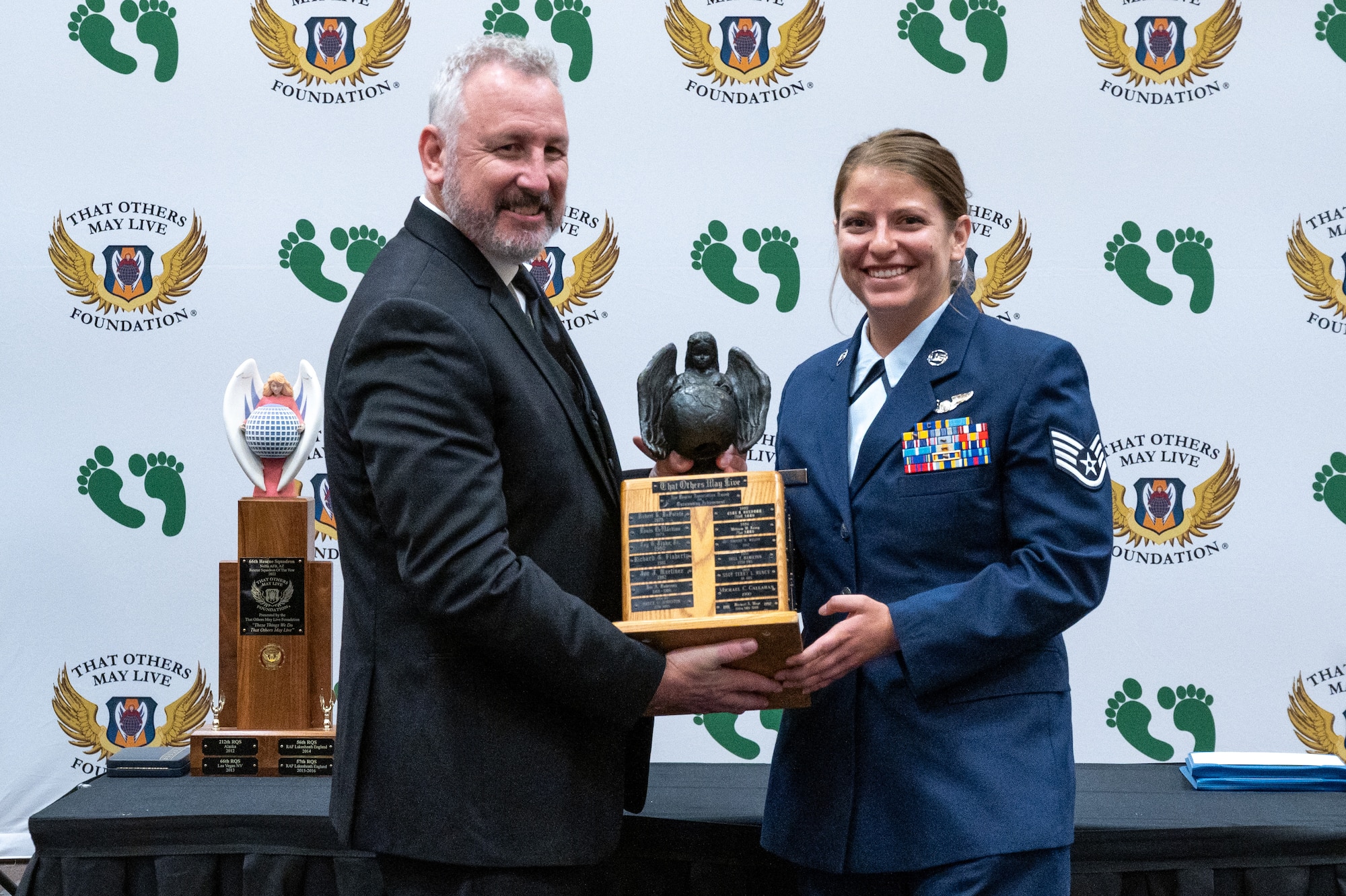Chris Barnett, left, president of the Air Rescue Association, presents the 2023 Air Rescue Association Richard T. Kight Award for the Most Outstanding Contribution to the Overall Rescue Mission to U.S. Air Force Staff Sgt. Caranda Gerke, a non-commissioned officer in charge of weapons and tactics assigned to the 56th Rescue Squadron from Aviano Air Base, Italy, at the 2023 Air Rescue Awards Gala in Las Vegas, Nevada, Sept. 23, 2023. Staff Sgt. Gerke is credited with saving six lives with various injuries from inaccessible topography. (U.S. Air Force photo by Airman 1st Class Elizabeth Tan)