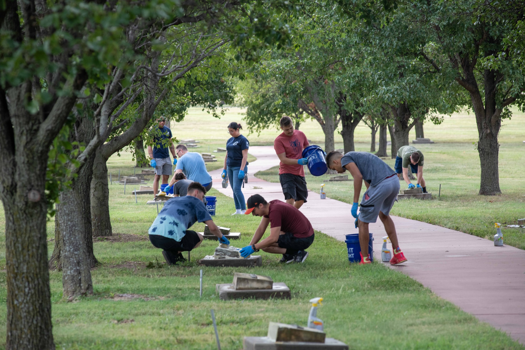 A group of volunteers help clean the monuments on the Memorial Walk at McConnell Air Force Base, Kansas, Aug. 26, 2023. This ambitious effort aims to clean all 301 memorial markers on the Walk annually, paying homage to the legacy of those who have served. (U.S. Air Force photo by Staff Sgt. Adam Goodly)