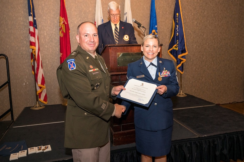 Senior Master Sgt. Jessica Barder, right, of the 193rd Special Operations Wing poses with Maj. Gen. James G. McCormack, assistant adjutant general, Pennsylvania National Guard, after receiving the prestigious Maj. Octavius V. Catto Medal at a ceremony Oct. 7 at the Union League of Philadelphia. (Pennsylvania National Guard photo by Staff Sgt. Wilfredo Acosta Jr.)
