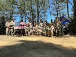 Deployed civil engineers from the 173rd Fighter Wing take a group photo after renovating a formerly abandoned Area Defense Command site near North Bend, Oregon, in late summer 2023. The site lay dormant for nearly 40 years and was overgrown with brush.