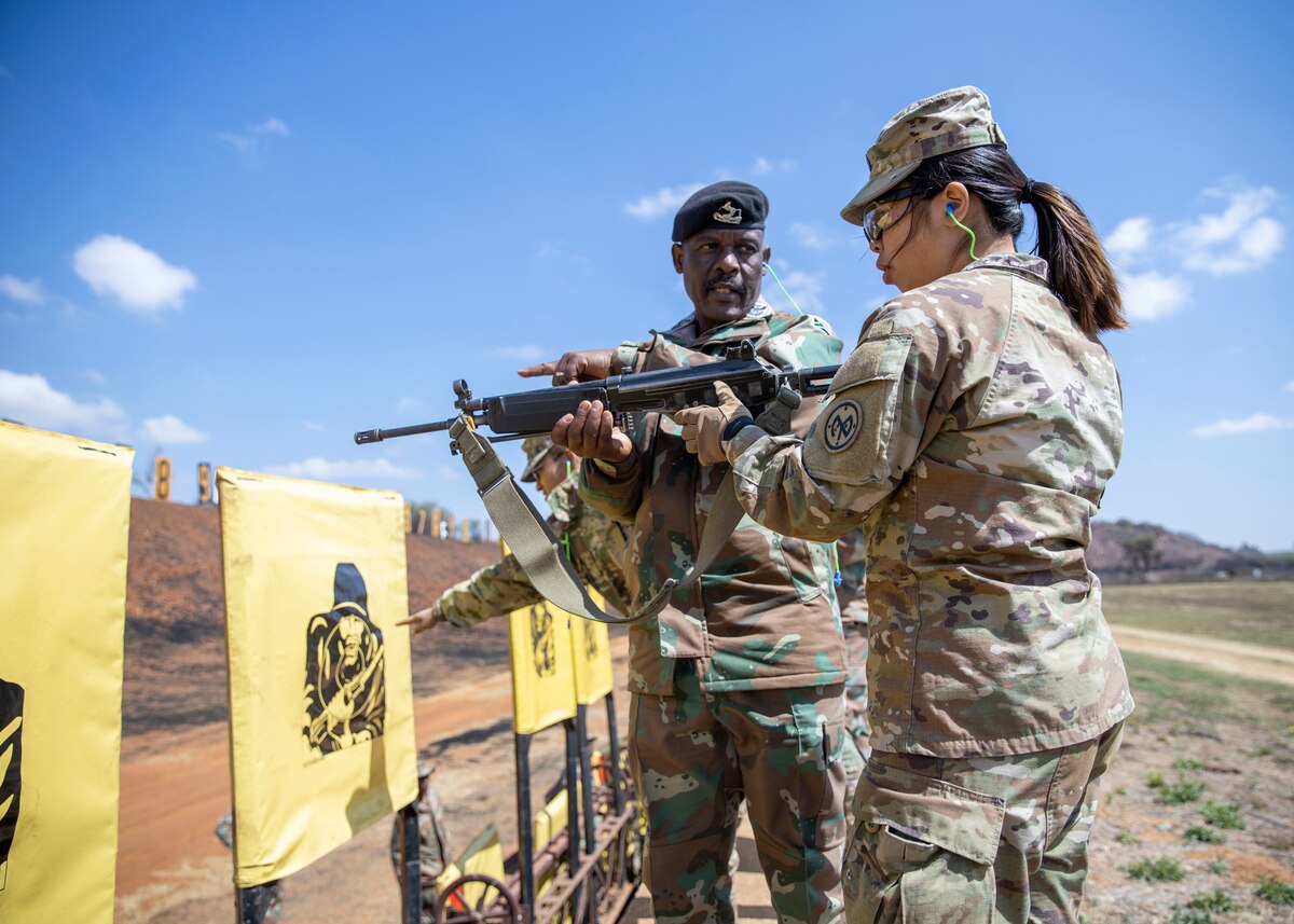 New York National Guard Staff Sgt. Quian Han gets marksmanship advice from a South African Army Senior warrant officer during the South African National Defence Force Military Skills Competition in Potchefstroom, South Africa, Sept.12, 2023. The week-long competition involved rifle and pistol marksmanship, a 5-mile run, grenade throwing, and a land/water obstacle course.