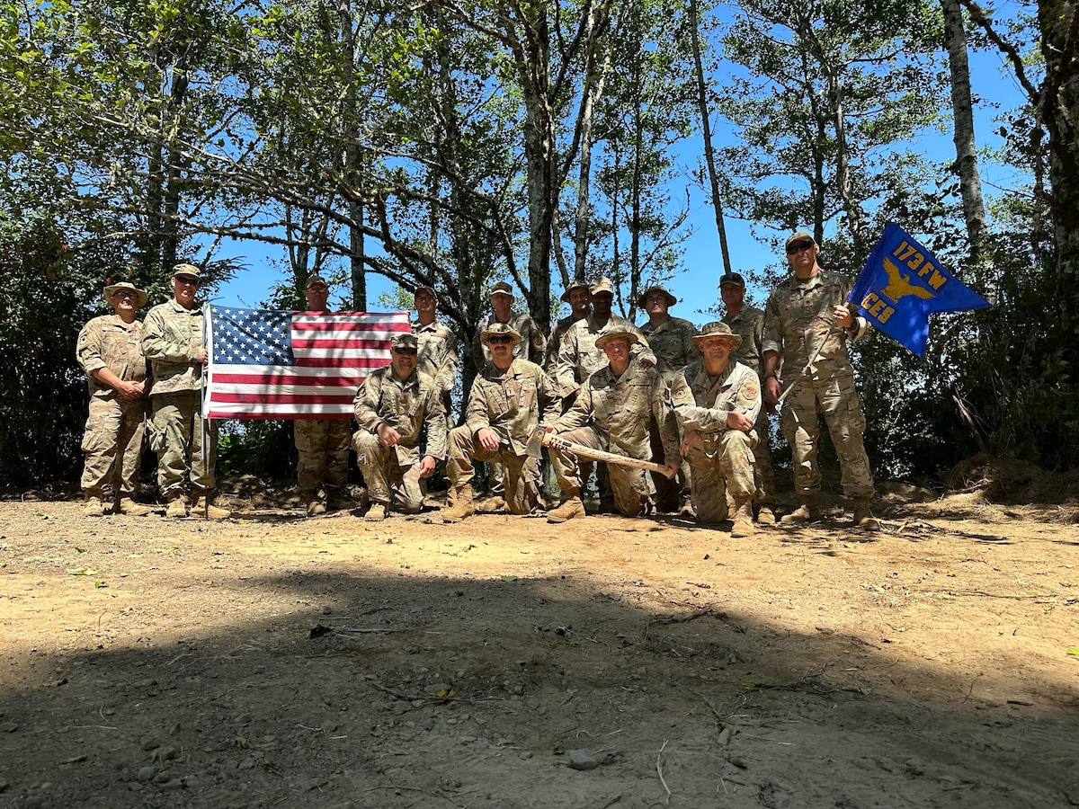 Deployed civil engineers from the 173rd Fighter Wing take a group photo after renovating a formerly abandoned Area Defense Command site near North Bend, Oregon, in late summer 2023. The site lay dormant for nearly 40 years and was overgrown with brush.