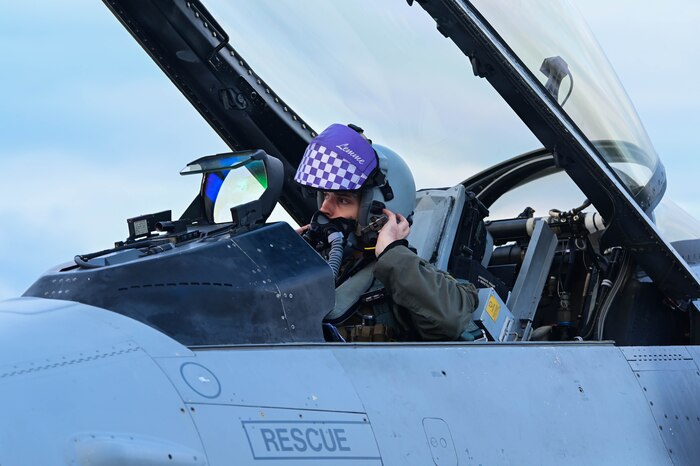 U.S. Air Force Capt. Scott “Lemme” Adams, 510th Fighter Squadron F-16 Fighting Falcon pilot, removes his helmet after a flight during Exercise Purple Reign.